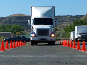 tractor trailer at truck driving school driving between orange cones